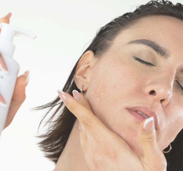 Woman applying a serum with a dropper